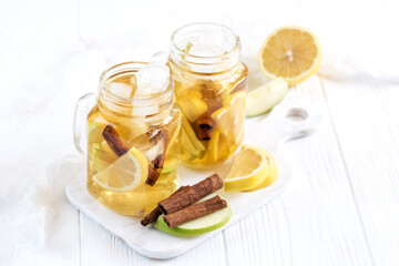 Infused water Fresh homemade ice tea with apple citrus and cinnamon