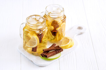 Infused water Fresh homemade ice tea with apple citrus and cinnamon