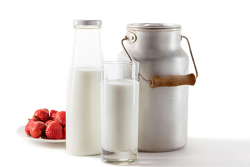 milk in can, bottle and glass with fresh strawberries isolated on white