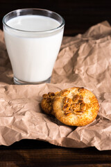 fresh milk in glass and homemade cookies on baking paper