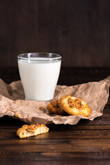fresh milk in glass and homemade cookies on baking paper