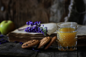 retro book and glass of orange juice in morning