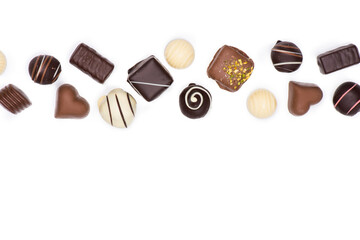 Top view of various gourmet chocolate candies isolated on white