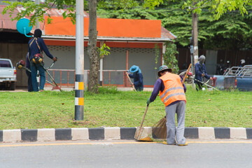Road sweeper worker cleaning city street with broom tool in Thailand