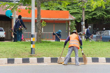 Road sweeper worker cleaning city street with broom tool in Thailand