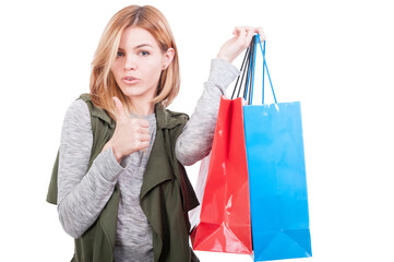 Beautiful female carrying colorful shopping bags