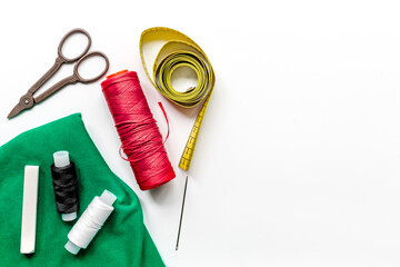 sewing hobby with tools, thread, scissors white background top view space for text