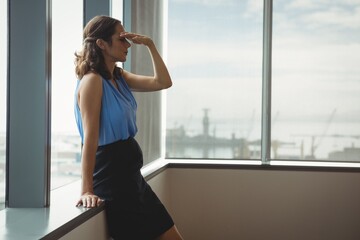 Tensed executive standing near window
