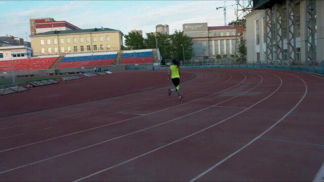 Girl running on the treadmill at a sports stadium