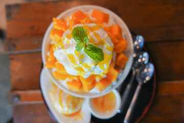 Soft focus Snow ice Bingsu mango with sweetened condensed milk, Korea dessert style