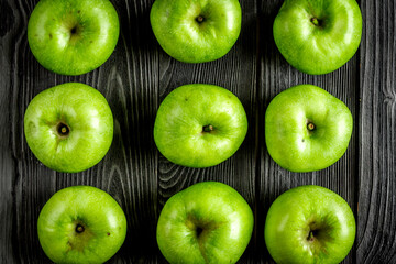 green apples close up pattern dark wooden desk background top view