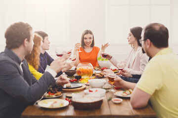 Obraz na płótnie Canvas Group of happy people at festive table dinner party