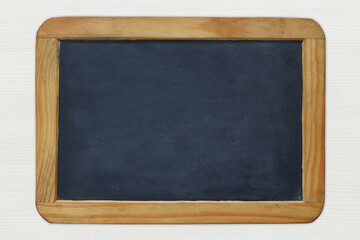 Empty vintage blackboard on white wooden background