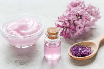 Obraz na płótnie Canvas lilac natural cosmetic set for spa with salt stone table background