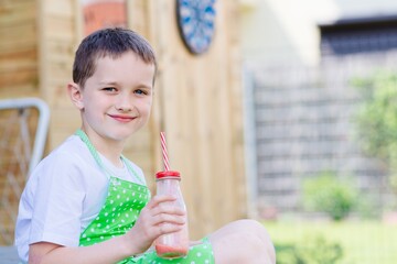 Child drinking strawberry banana cocktail