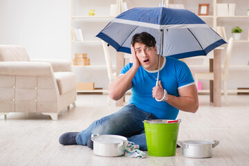 Man at home dealing with neighbor flood leak
