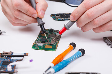 Repairing smartphone with multimeter close up