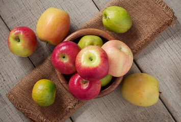 Apples in a bowls on wooden.