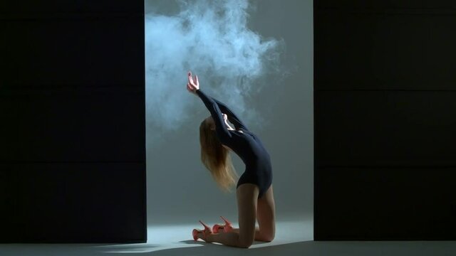 Beautiful young woman is dancing showing her flexibility and stretching
