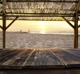 empty bar table against sunset at the beach
