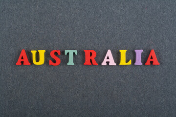 AUSTRALIA word on black board background composed from colorful abc alphabet block wooden letters, copy space for ad text. Learning english concept.
