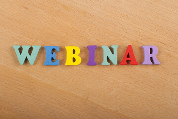 WEBINAR word on wooden background composed from colorful abc alphabet block wooden letters, copy space for ad text. Learning english concept.