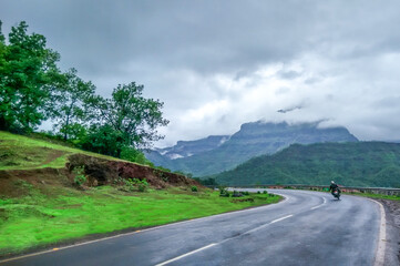 Asphalt road in the misty mountains / landscape / highway in the mountains