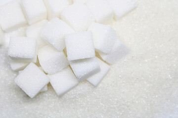 Pure refined sugar and sugar cubes. Sweet food ingredient, the diet health risks related to diabetes and calorie intake.