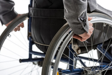 cropped shot of physically handicapped man on wheelchair isolated on white