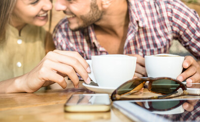 Fashion couple of young lovers at cafe bar cafeteria - Handsome man whisper sexy tender kisses to pretty woman - Relationship love concept with boyfriend and girlfriend together - Warm vintage filter