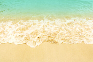 Soft wave on the beach. Summer season on empty tropical beach with waves and clear sand.