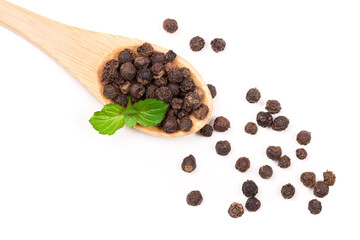 Black peppercorn in a wooden spoon isolated on white background. Top view