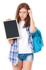 Beautiful teen girl with small blackboard and backpack, isolated on white background - back to school concept. 