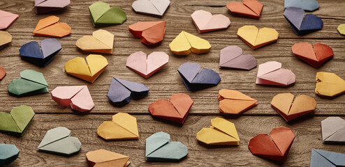 Colorful Handmade origami hearts background on table