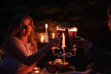 Glasses by candlelight during a dinner outdoors