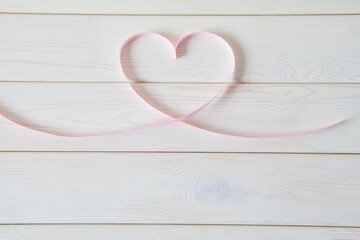 Valentines day card - heart made of ribbon on white background