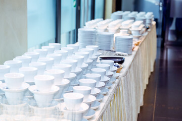 Catering table with dishes and snacks on the business event in the hotel hall. Close up, selective focus.