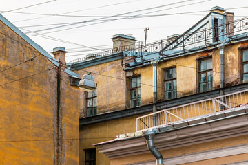 Composition of pieces of three different facades of apartment buildings with a lot of wires.