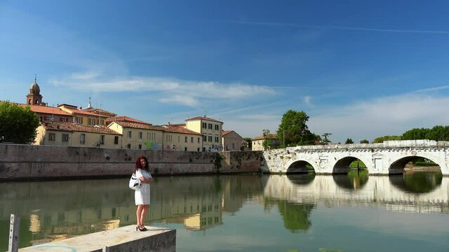 lady in front of ancient Roman bridge