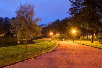 Night view of alley, park and pond in Yusupov Garden, Saint Petersburg, Russia.