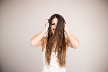 Happy girl dancing and listening to the music isolated