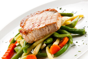 Roast steak with beans on white background