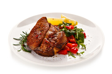 Grilled beefsteak with vegetables on white background