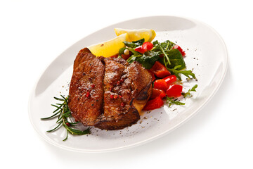 Grilled beefsteak with vegetables on white background