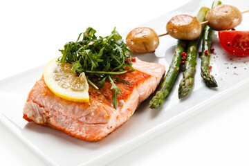 Grilled salmon with asparagus on white background