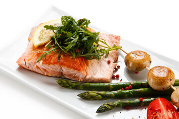 Grilled salmon with asparagus on white background