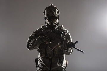 Army soldier in Protective Combat Uniform holding Special Operations Forces Combat Assault Rifle....