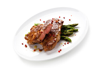 Grilled beefsteak with asparagus on white background
