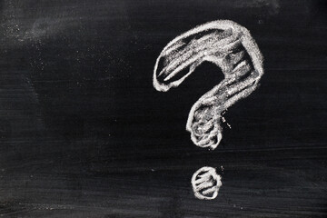 Chalk hand drawing as question mark shape on black board background
