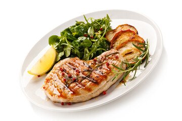 Grilled steak with vegetables and roast apples on white background